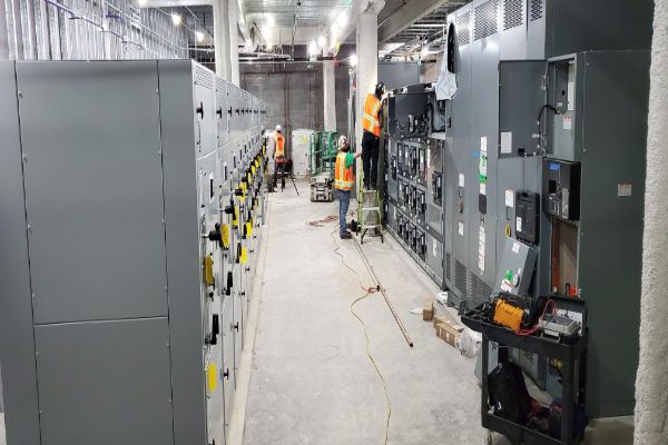 engineers installing switchgear panels