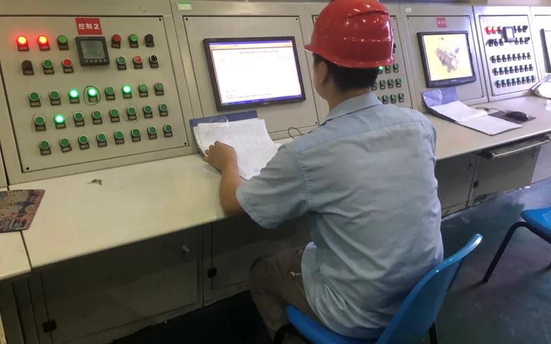 Operator monitoring a diesel generator during a full-load test on the resistive load bank at H&C's factory in Jiangsu, China