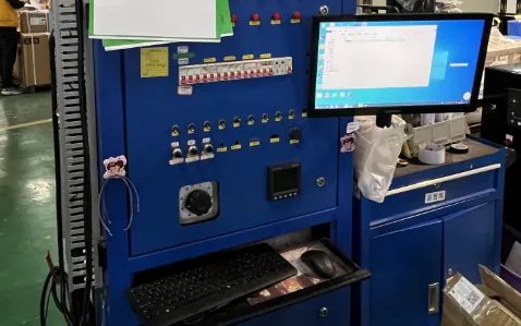 Control cabinet wiring and full-cabinet testing on the instrumented bench at H&C factory