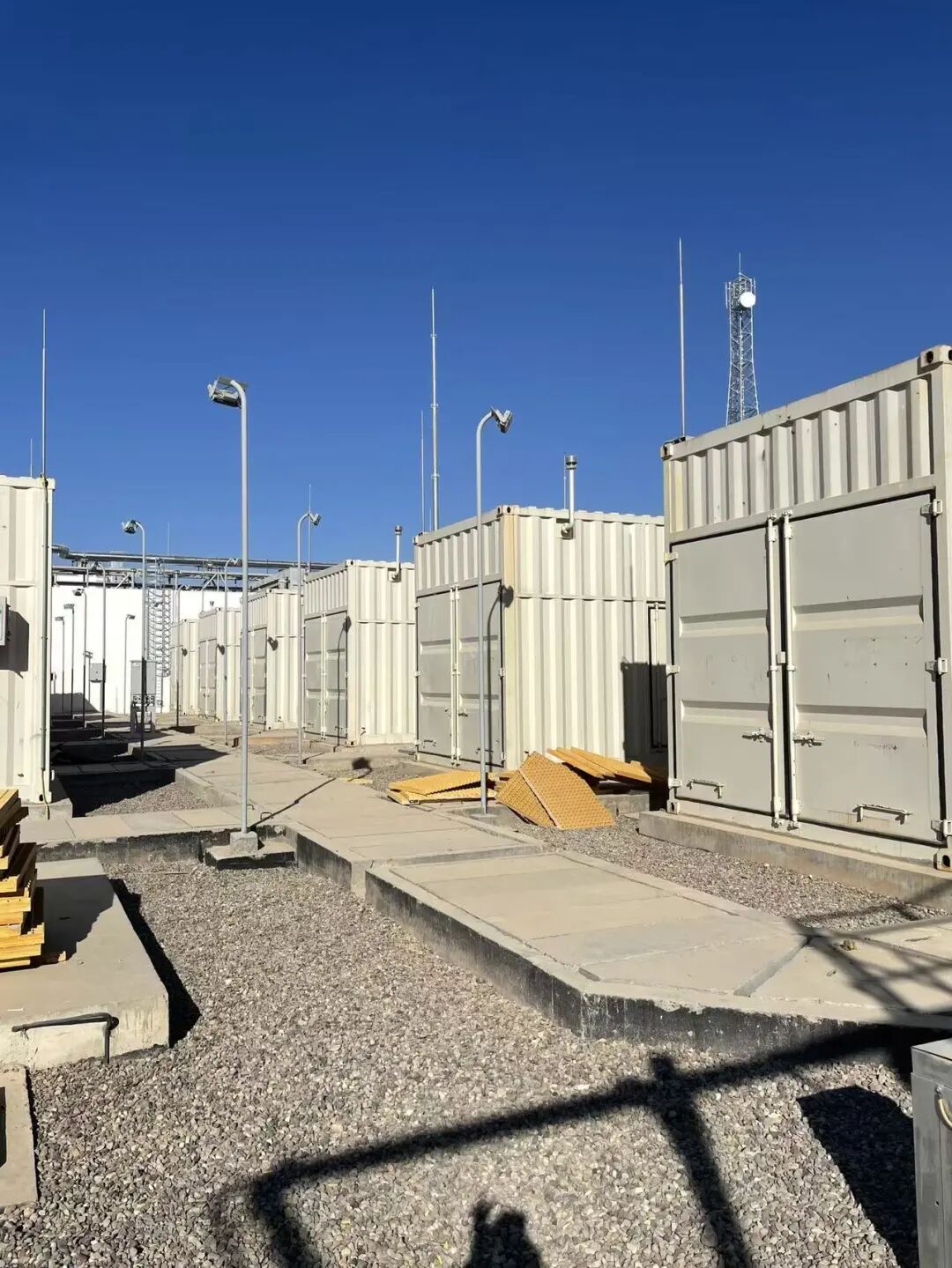 Containerized Mitsubishi generator sets and light poles at the Middle East power plant site