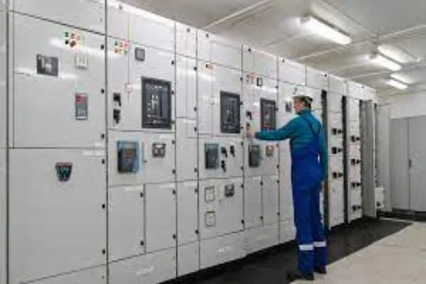 engineer operating switchgear panel