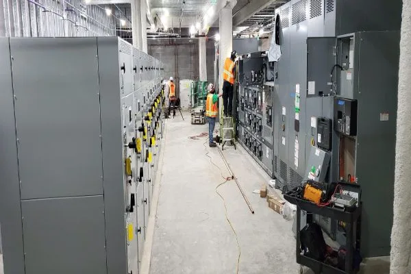 engineers installing switchgear panels, ensuring efficient power distribution