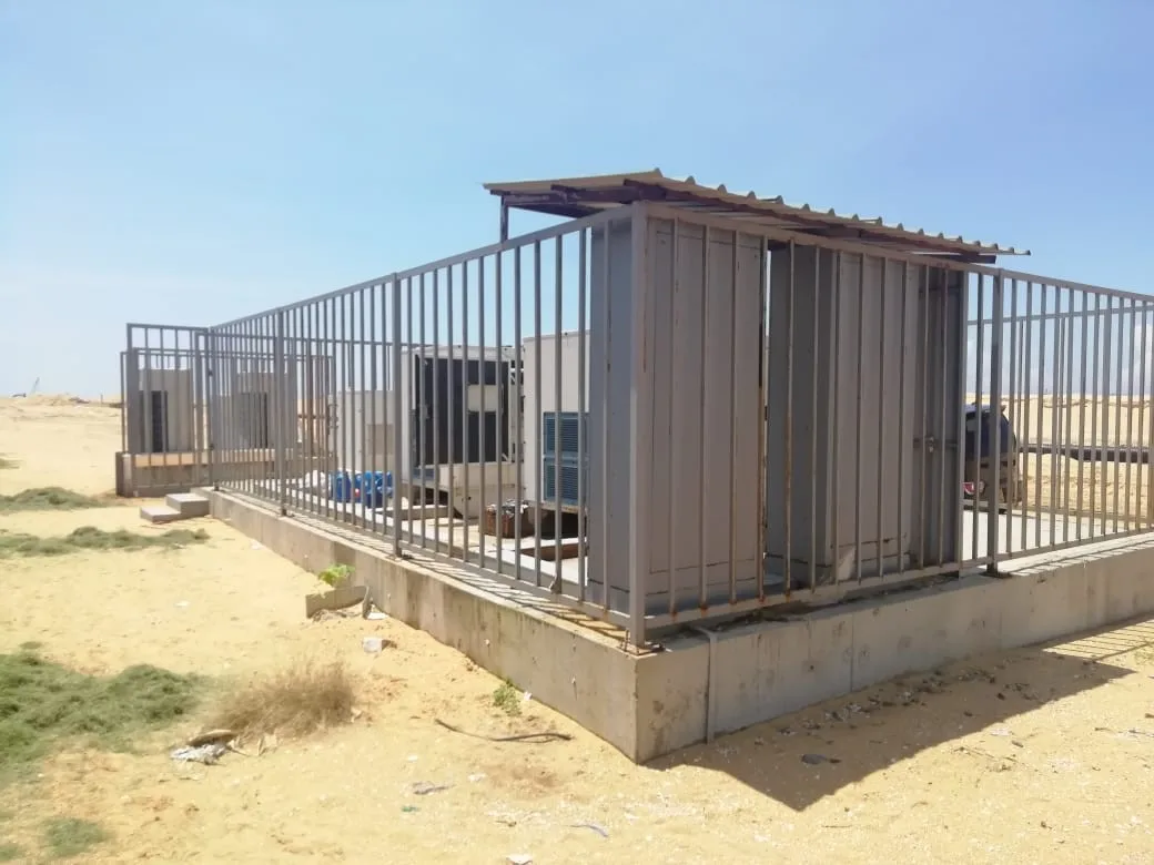 outdoor diesel generator set, secured in a fenced enclosure